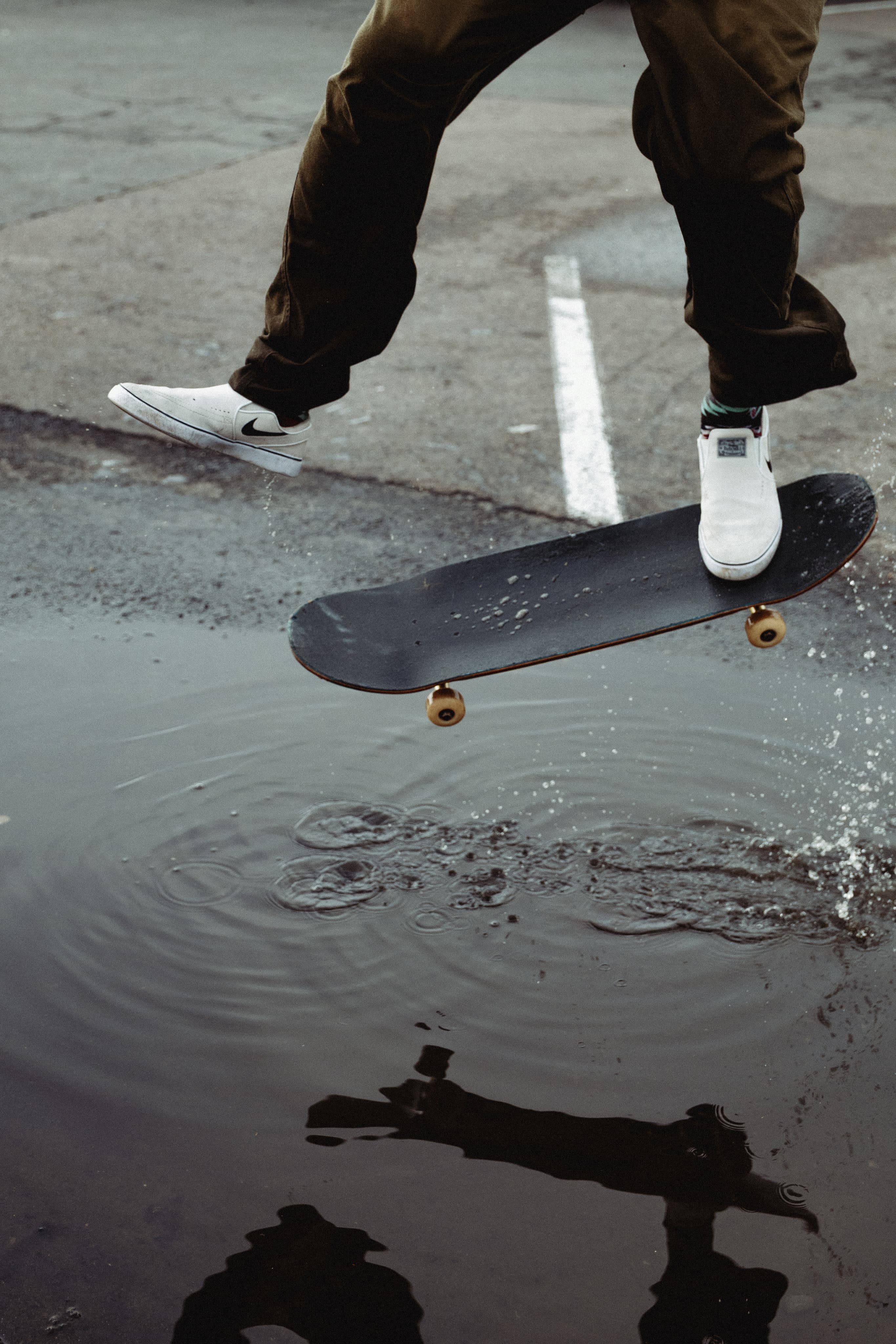 Skateboard trick with wet-ground reflection